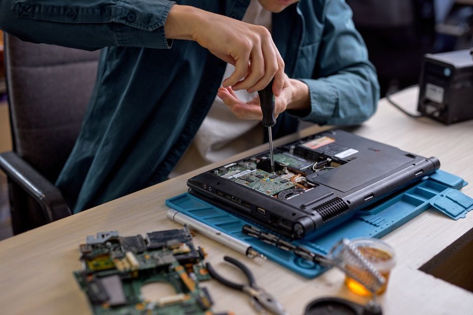 expert repairing laptop