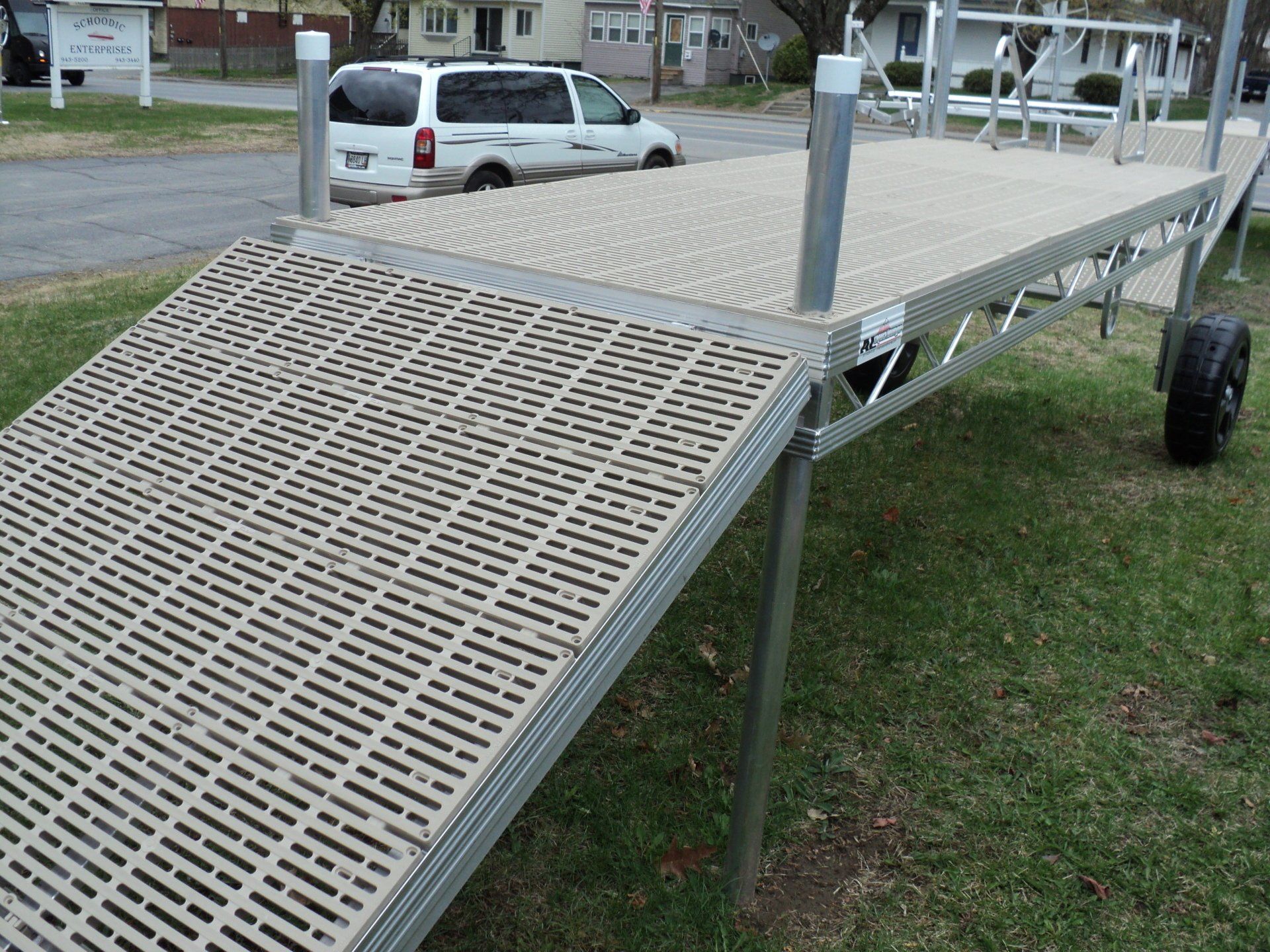 A white van is parked on the side of a dock