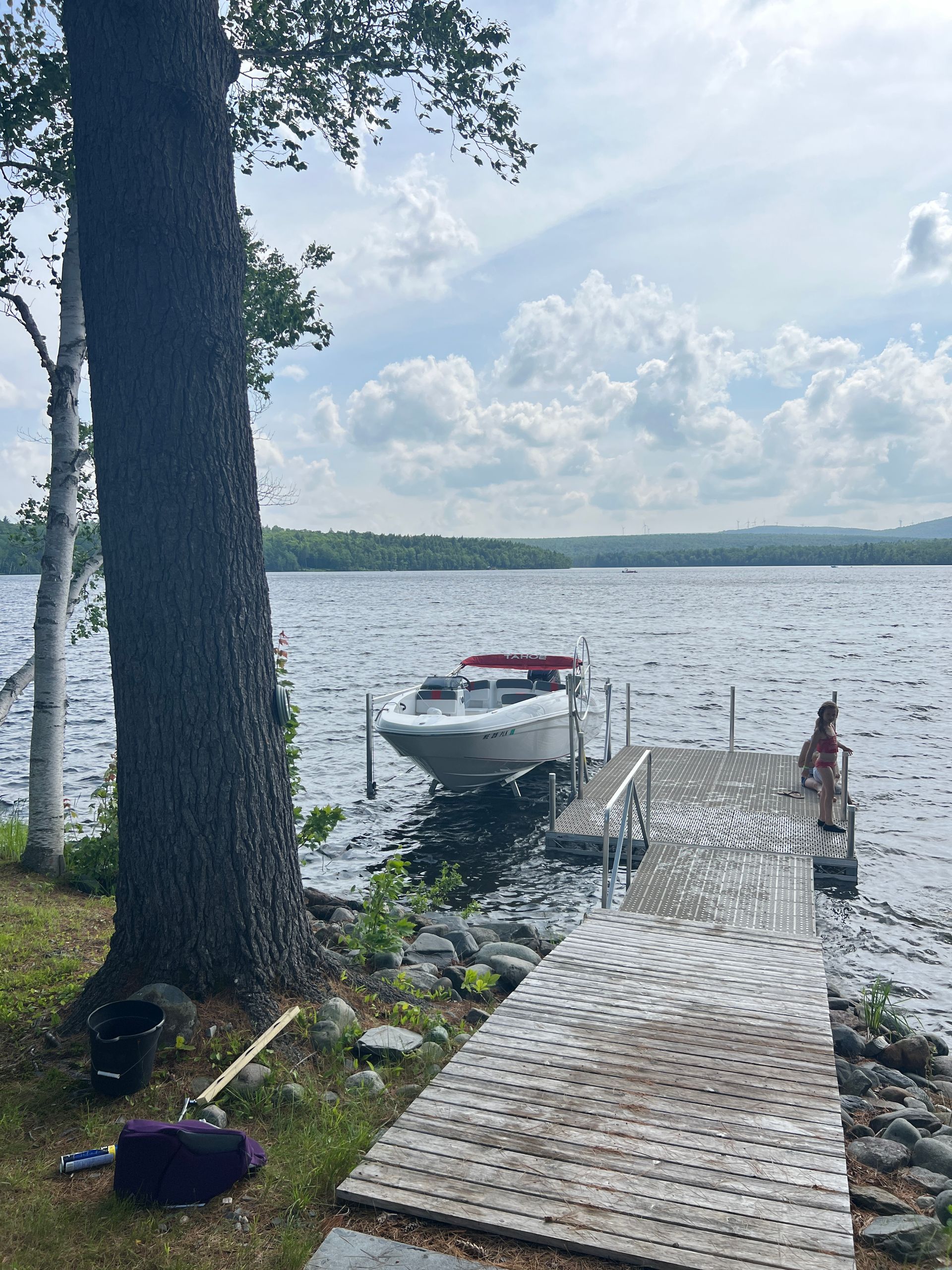A boat is docked at a dock on a lake.