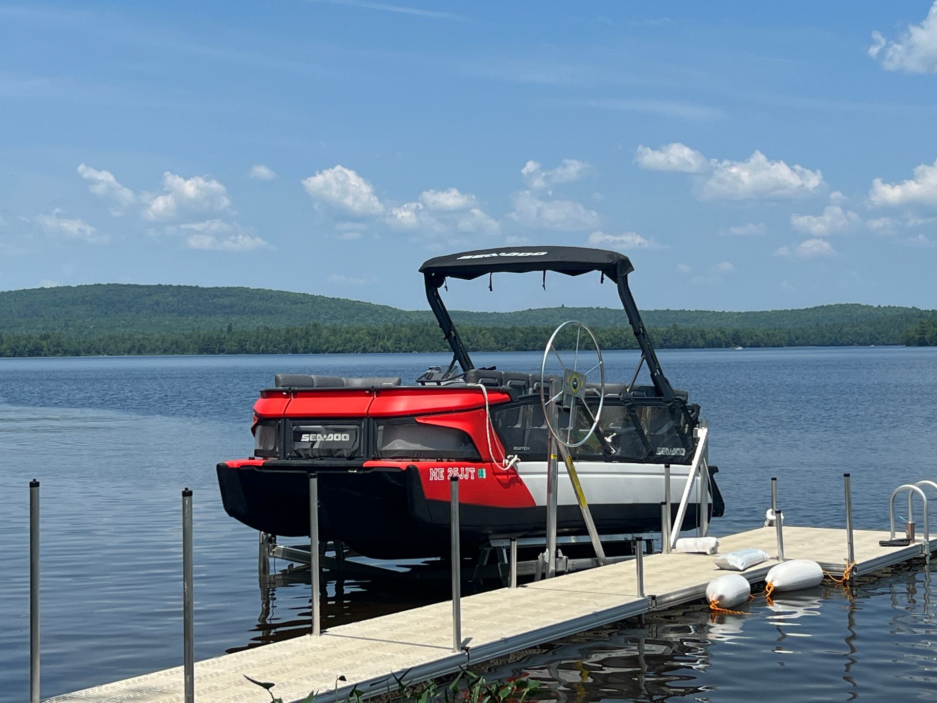A boat is docked at a dock on a lake.