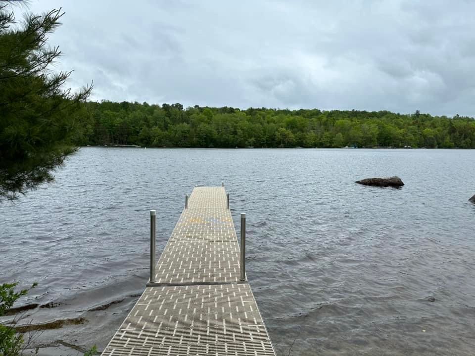 There is a dock in the middle of a lake.