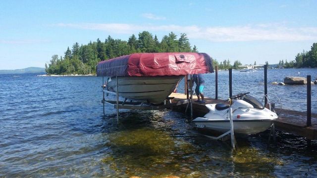 Boat on boat lift next to dock