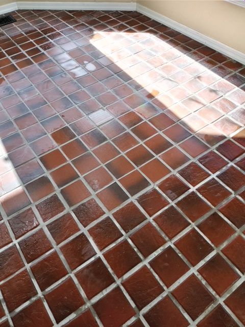 A display of various rectangular wall and floor tiles in marble, stone, and patterned styles, arranged in a showroom.