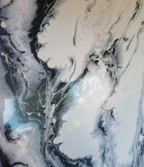 Abstract acrylic pour painting featuring swirling, marbling patterns of black, white, and subtle hints of blue and green.