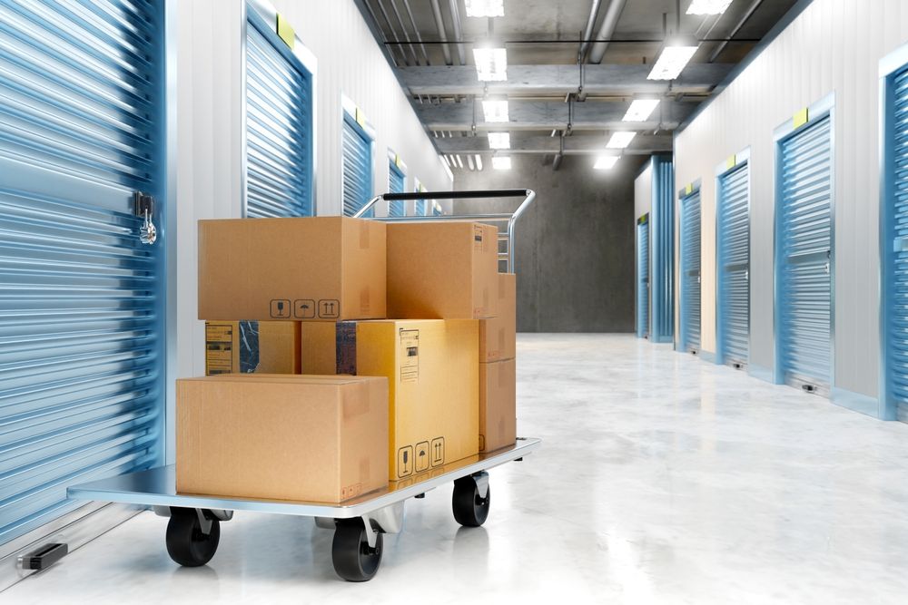 A cart filled with cardboard boxes in a storage room.