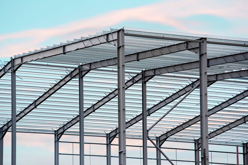 A large metal structure under construction with a blue sky in the background.