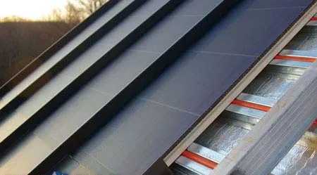 Solar panels integrated into a roof, angled, with visible seams and reflective insulation layers.