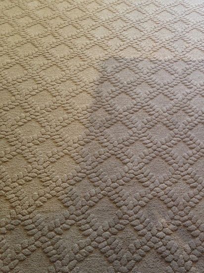 A close up of a carpet with a pattern on it.