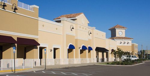A large building with a parking lot in front of it.