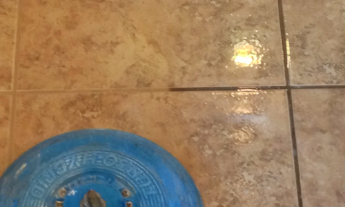 A vacuum cleaner is being used to clean a carpet.