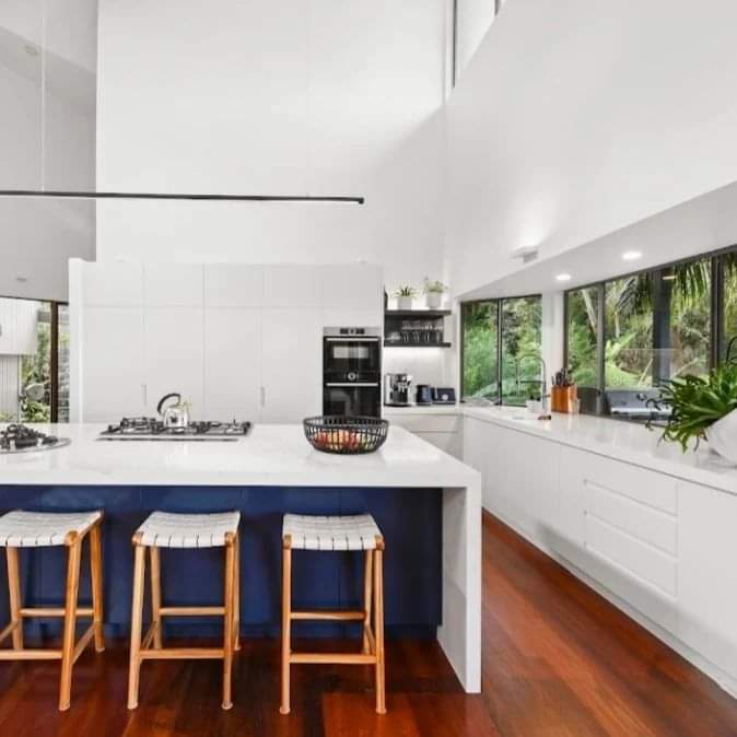 Large White and Navy Kitchen Island with Rattan Stools — DMB Kitchens in Port Macquarie, NSW