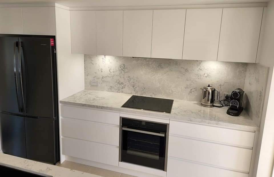 White Kitchen Cabinetry With Electric Stovetop — DMB Kitchens in Port Macquarie, NSW