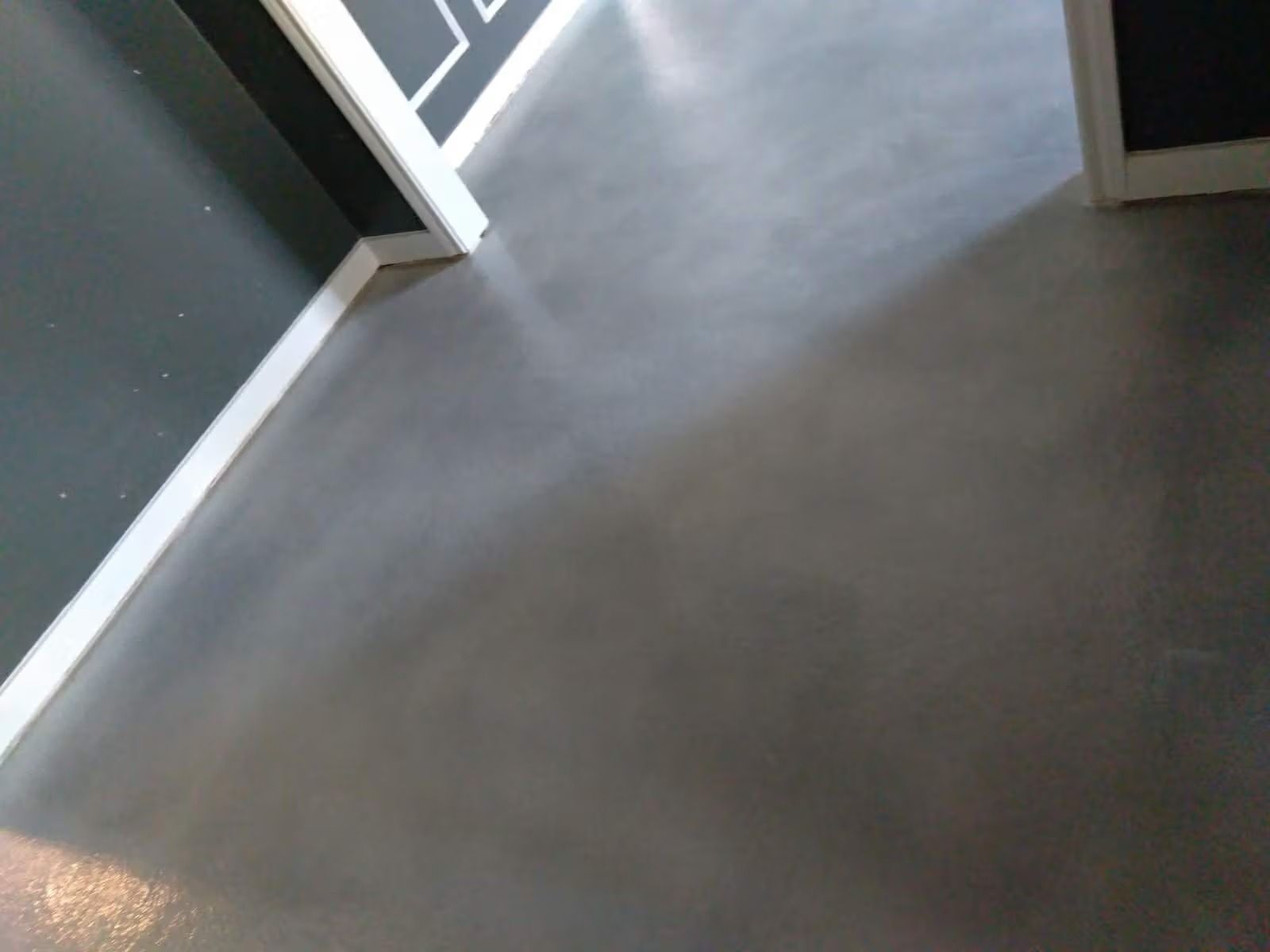 Gray concrete floor with white trim.