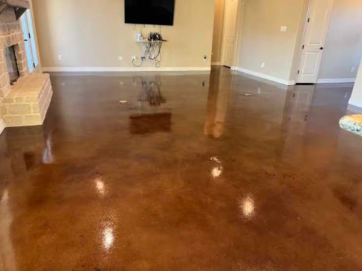 Brown glossy stained concrete floor with light reflections in a room.