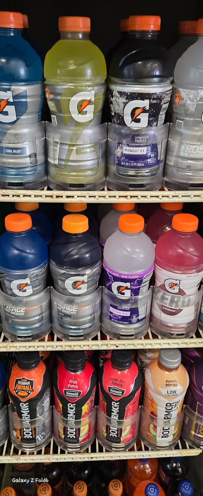 A vending machine filled with bottles of gatorade and other beverages.