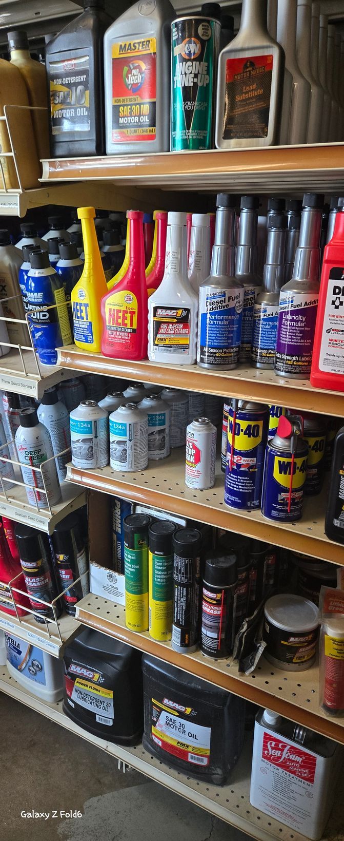 A store shelf filled with lots of different types of cleaning products.