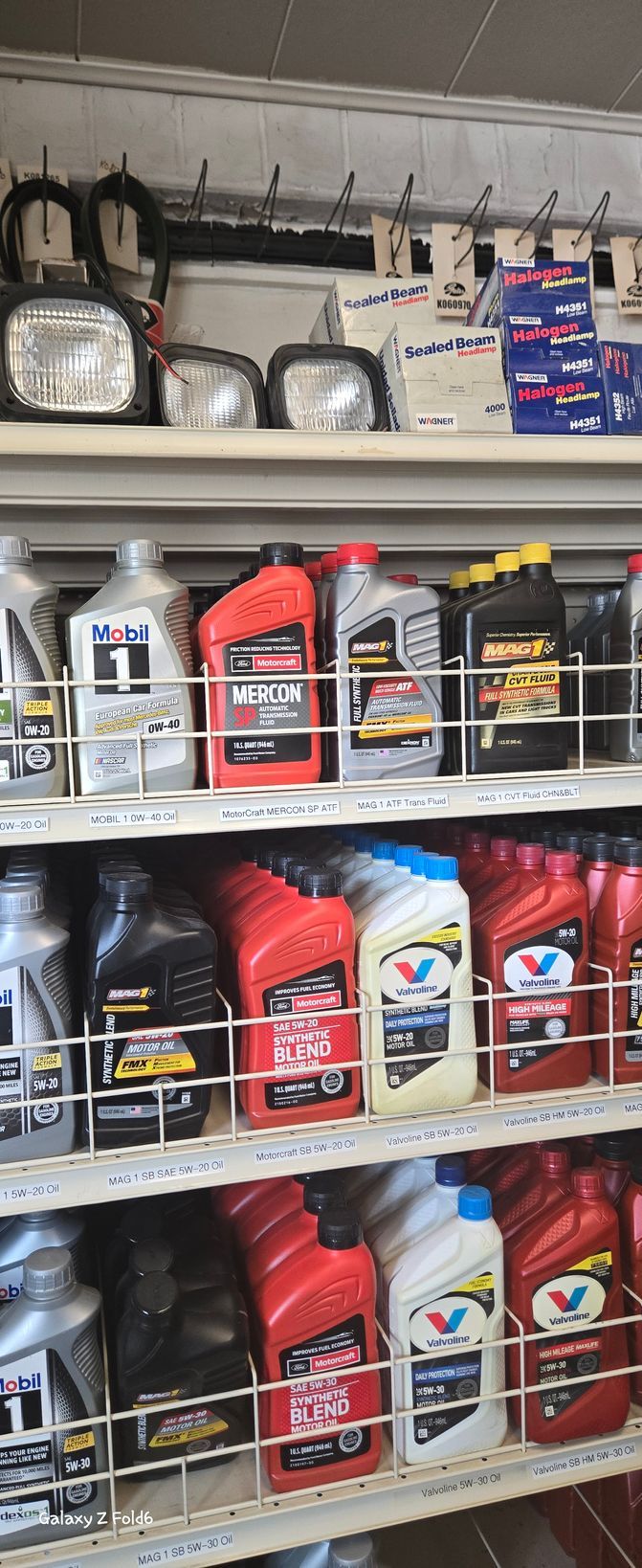 A store shelf filled with lots of bottles of oil.
