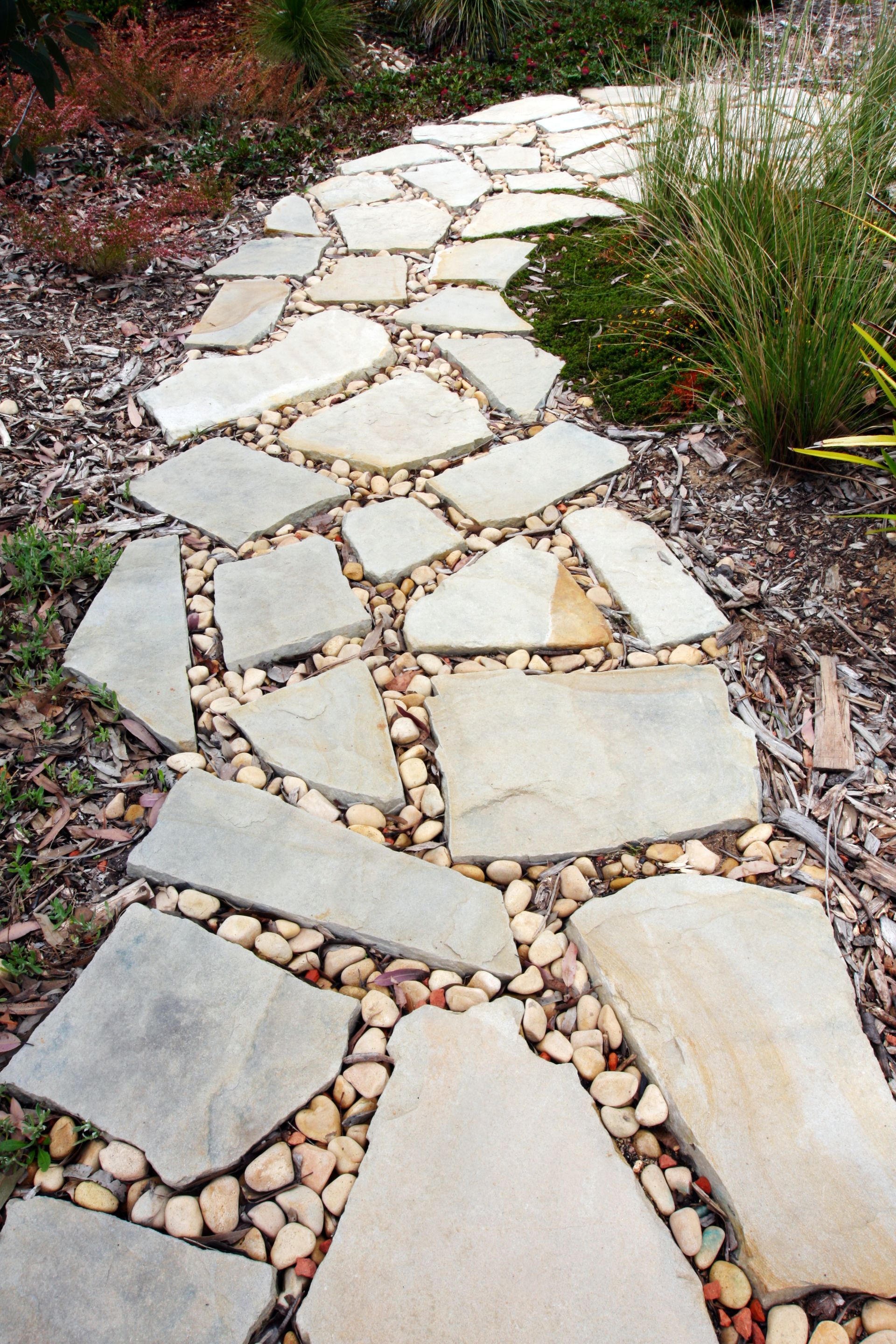 A walkway made of rocks and gravel in a garden