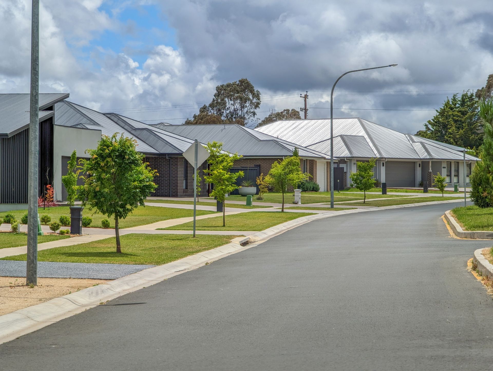 A row of houses are lined up on the side of a street in a residential area.