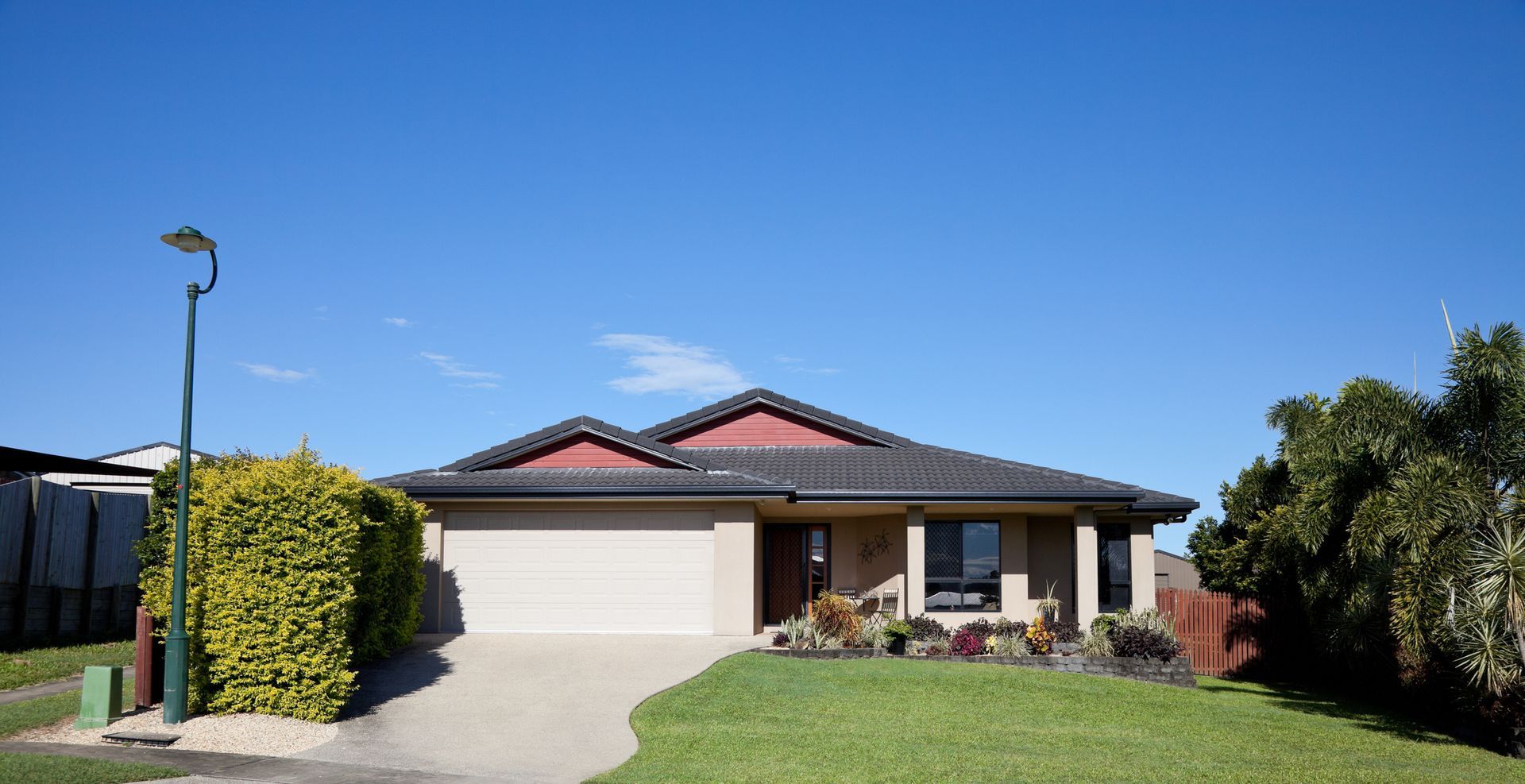 A house with a large lawn in front of it