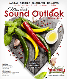 Marlene's Sound Outlook magazine cover with chili peppers, basil, and garlic arranged on a heart-shaped wooden board.