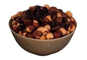 A bowl filled with a mix of hazelnuts, chocolate chips, and dark raisins.