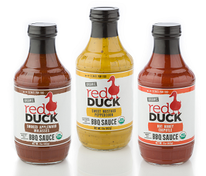 Three Red Duck Organic BBQ Sauce bottles: Smoked Applewood Molasses, Sweet Mustard Pepper, and Hot Honey Chipotle.
