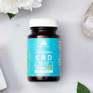 Bottle of CBD capsules with a blue label and white lid, on a marble surface with flowers.