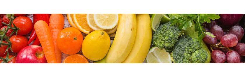 Arrangement of various fruits and vegetables in a rainbow spectrum of colors, from red to purple.