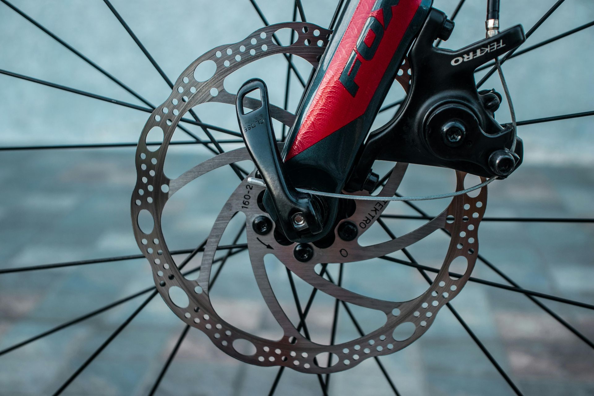 Close-up of a bicycle wheel with a disc brake, showing the brake rotor and caliper assembly.