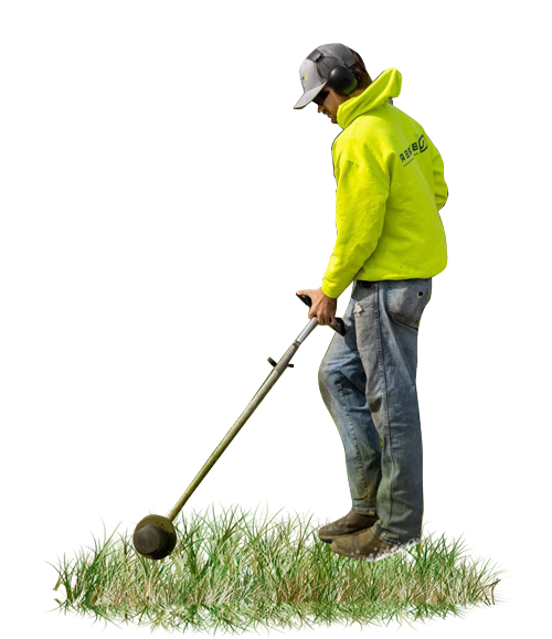 Worker in a neon yellow jacket using a weed trimmer on grass