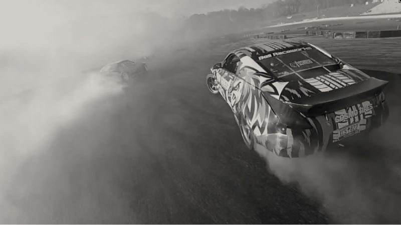 Race car drifting, generating large clouds of smoke on a track.