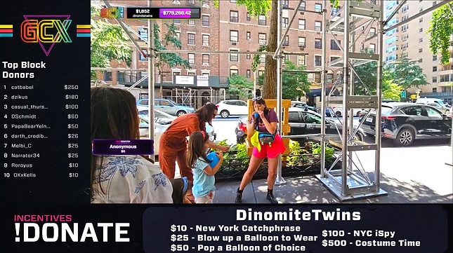 A woman and child playing with balloons. A live stream overlay shows donation goals and top donors. City background.