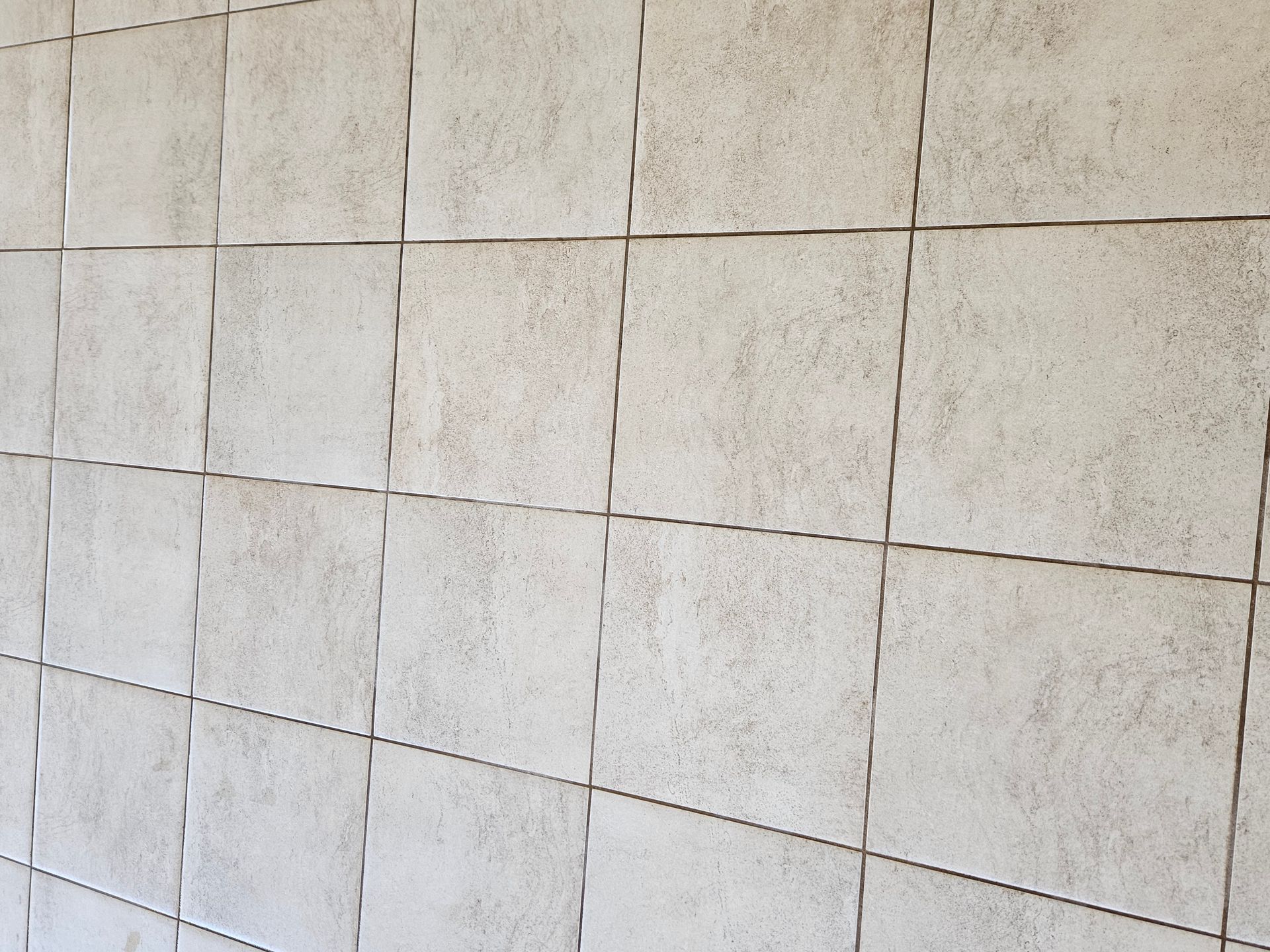 Side view of grey white tiles and their grout lines - Pinnacle Carpet Cleaning in Central Coast, NSW