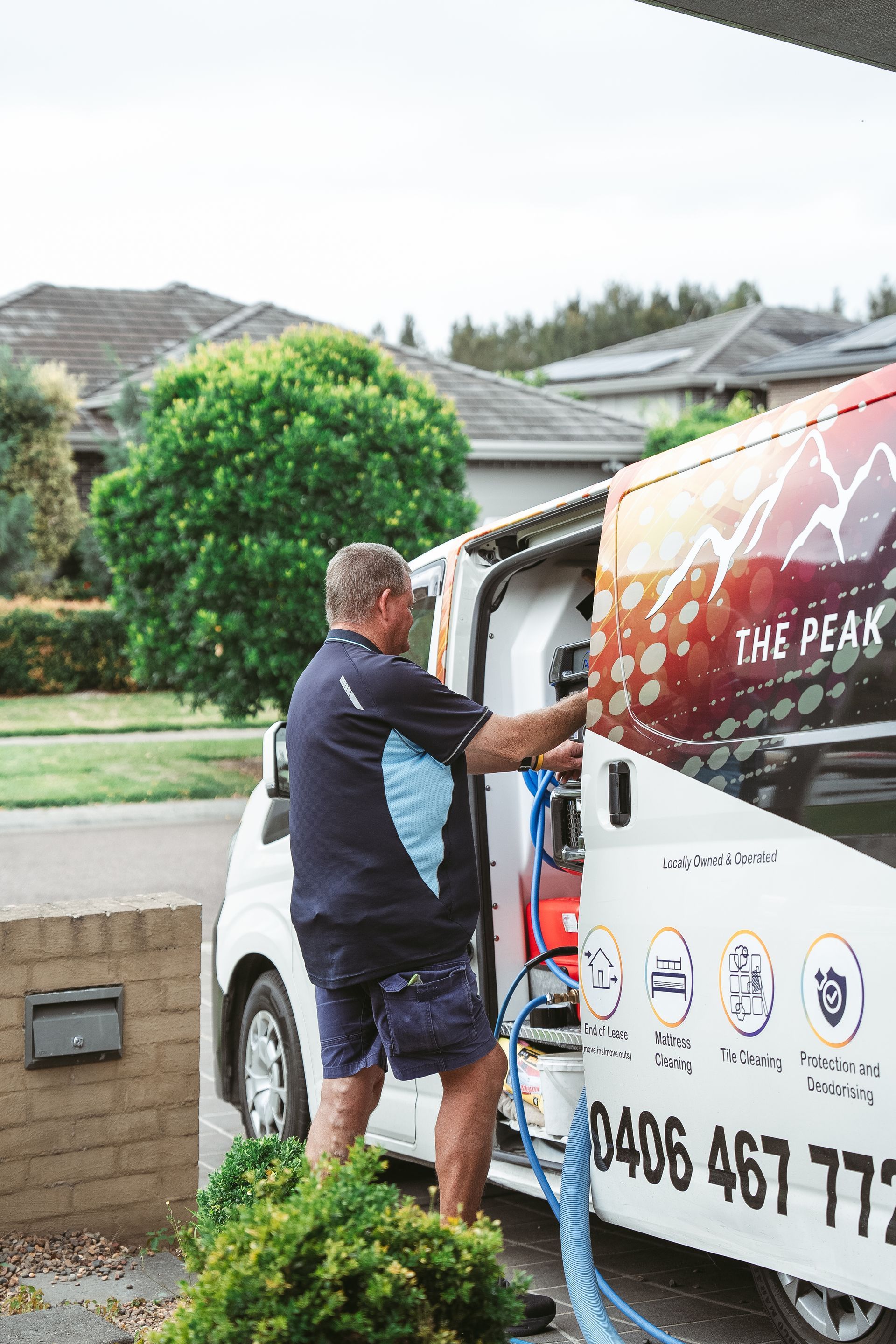 A man is loading a hose into a van. — Pinnacle Carpet & Upholstery Cleaning In Wyong, NSW