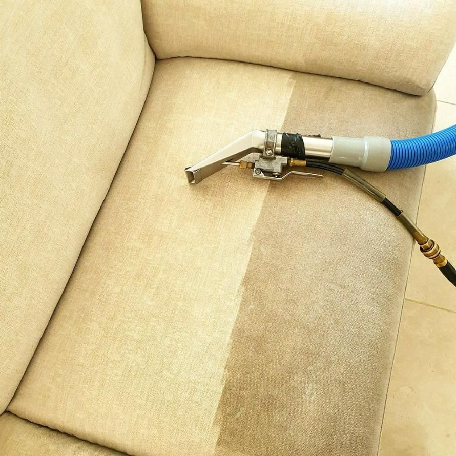 A Couch Is Being Cleaned With A Vacuum Cleaner — Pinnacle Carpet & Upholstery Cleaning In Wyong, NSW