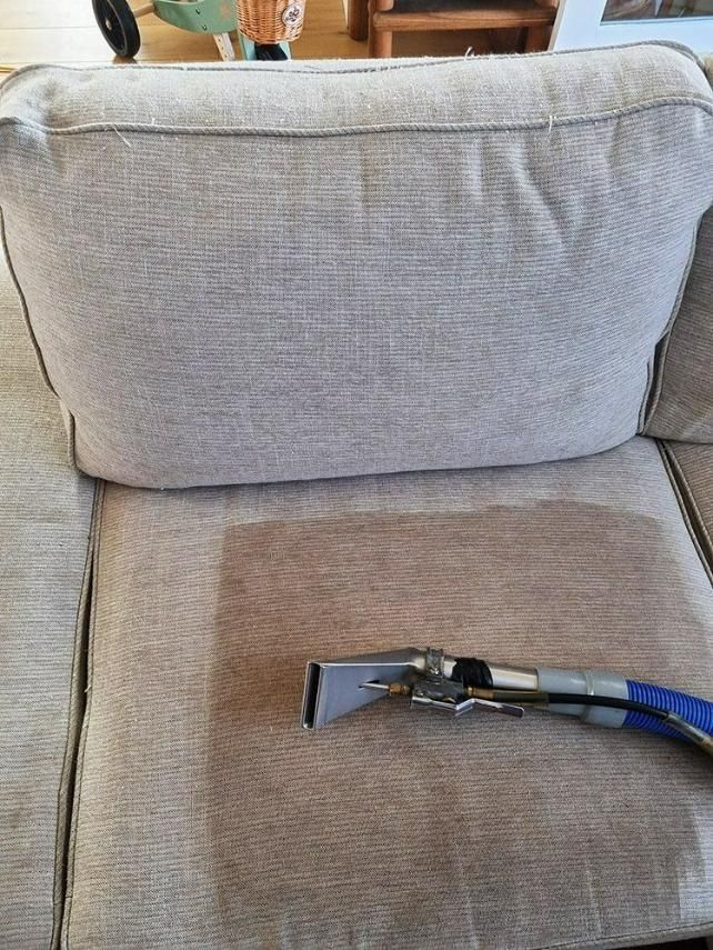 A vacuum cleaner is sitting on the back of a couch. — Pinnacle Carpet & Upholstery Cleaning In Wyong, NSW