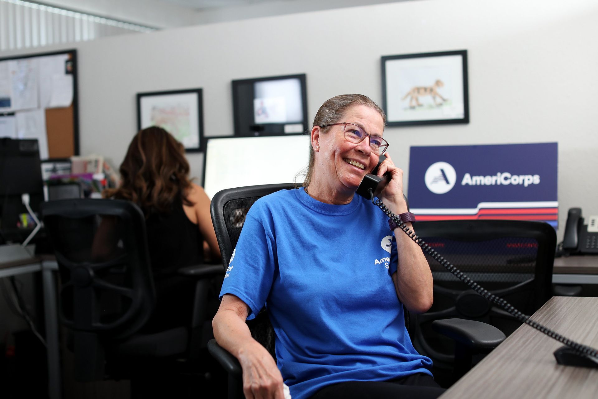 Volunteer on a phone call at a generic RSVP volunteer station.