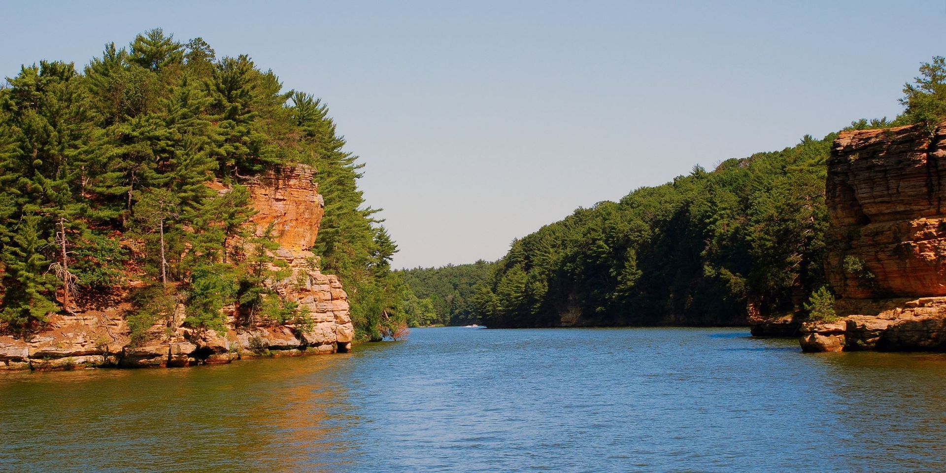 Lake Superior against cliff faces with pine trees