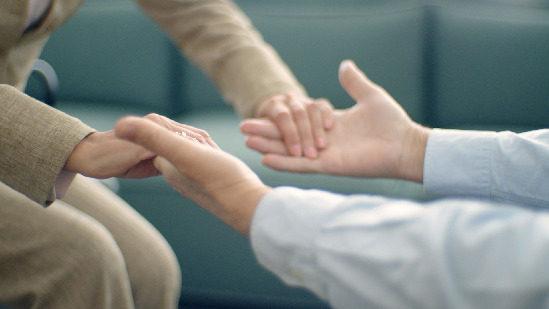 a set of hands helping another set of hands up