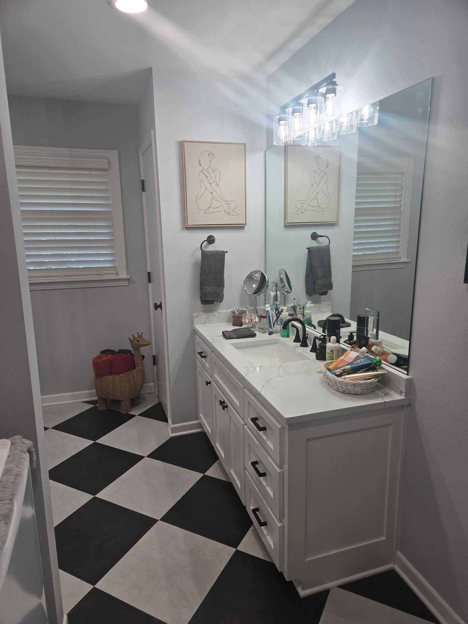 A man is giving a box to a woman in front of a van full of boxes