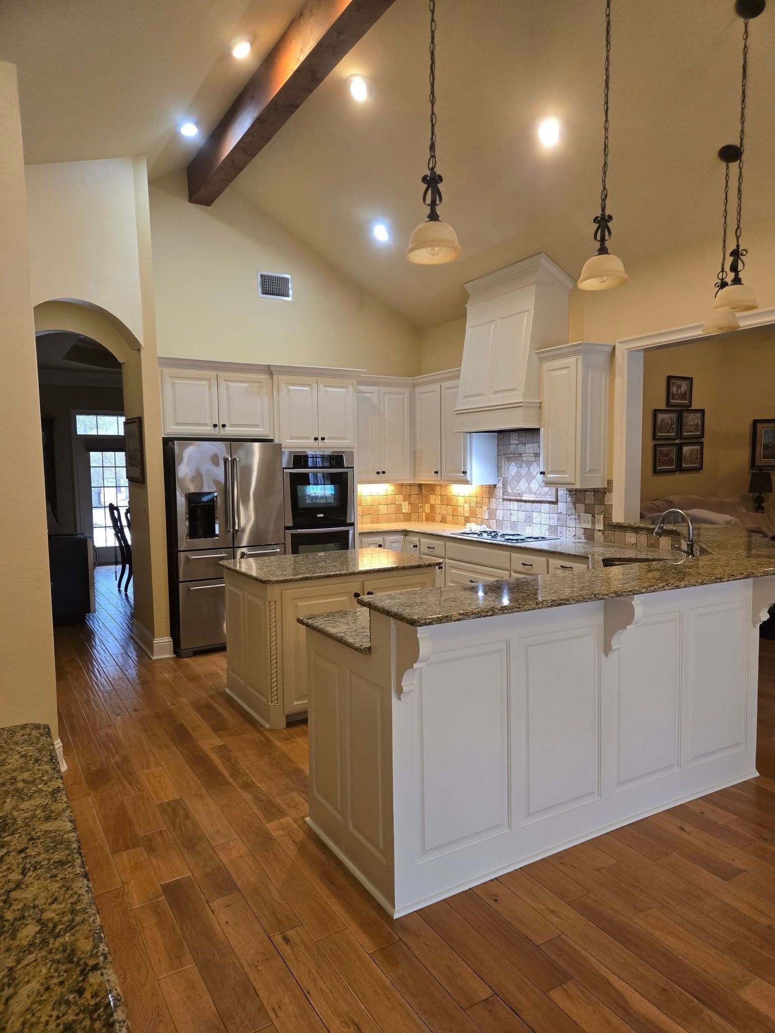A kitchen with white cabinets and granite counter tops