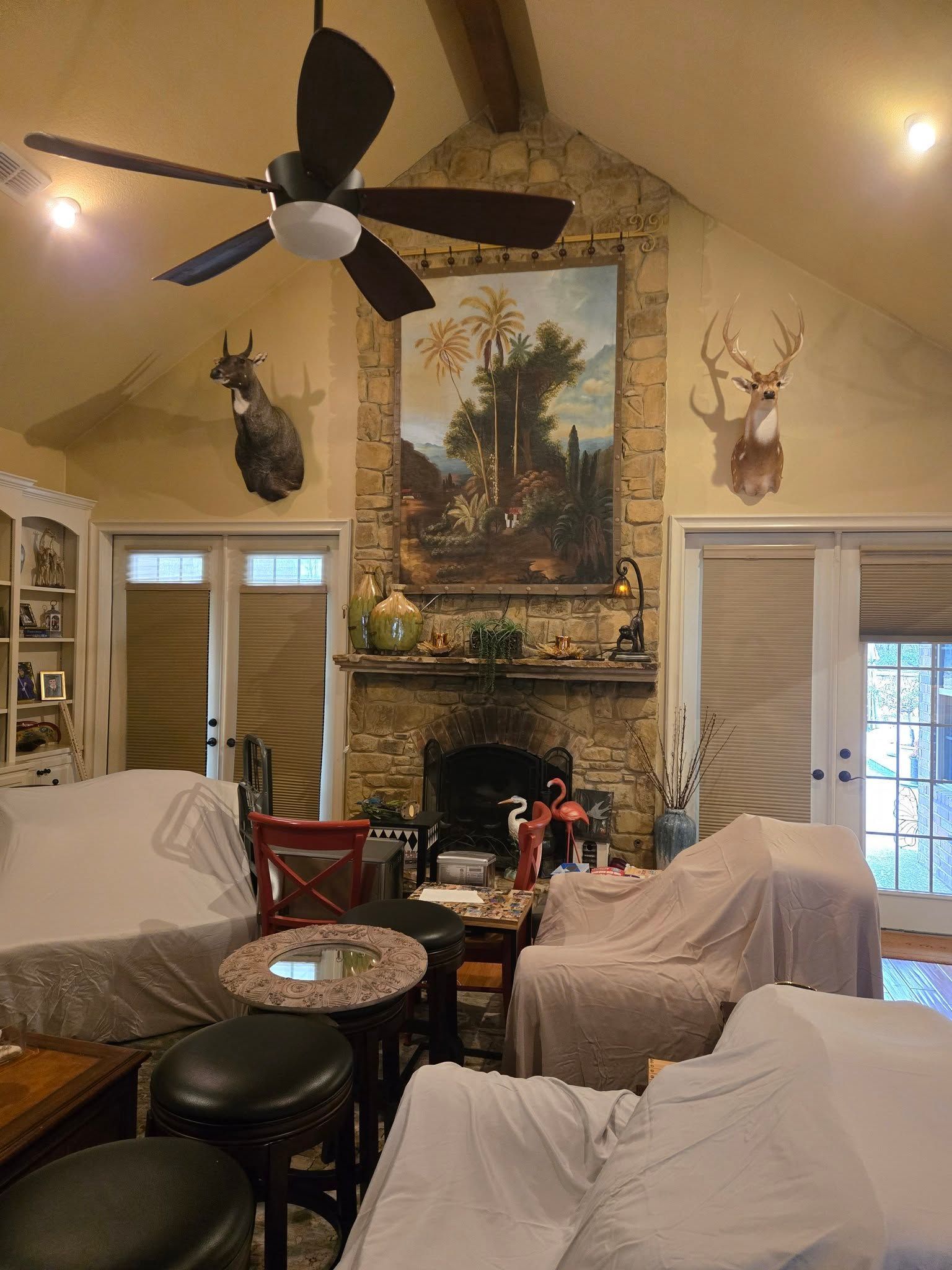 A living room with a fireplace and a ceiling fan