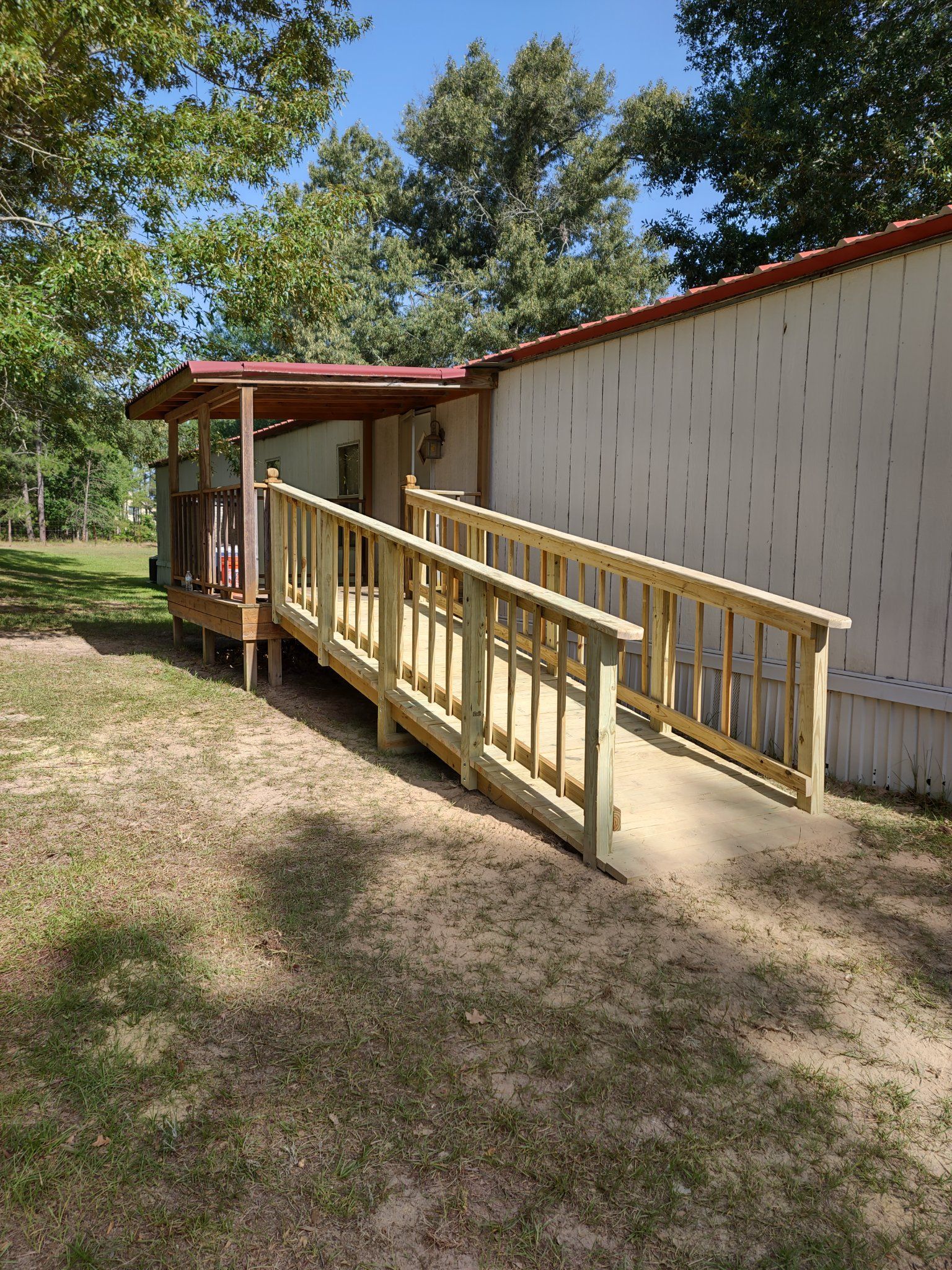 A wooden ramp is leading to a mobile home.
