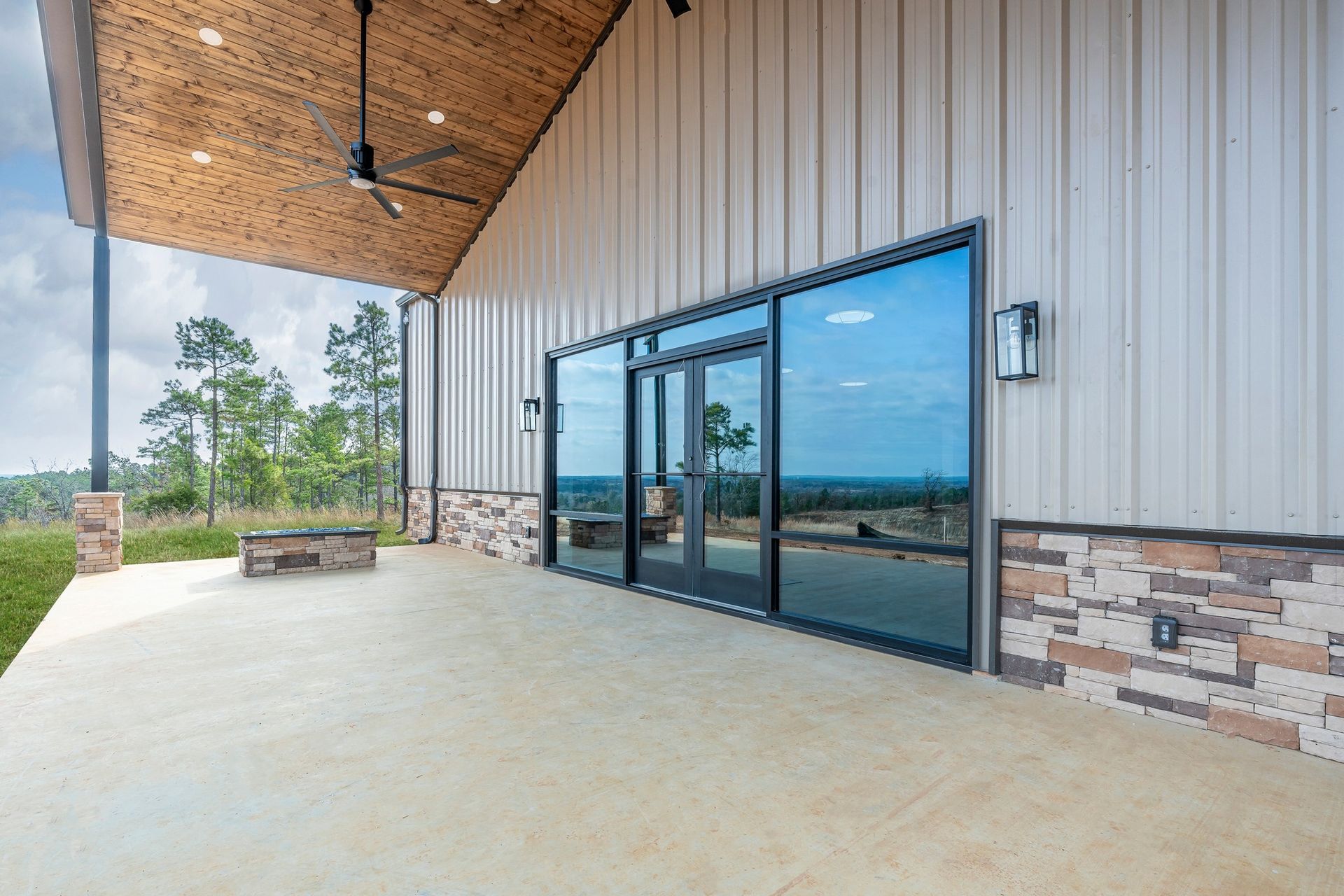 A large building with a lot of windows and a ceiling fan.