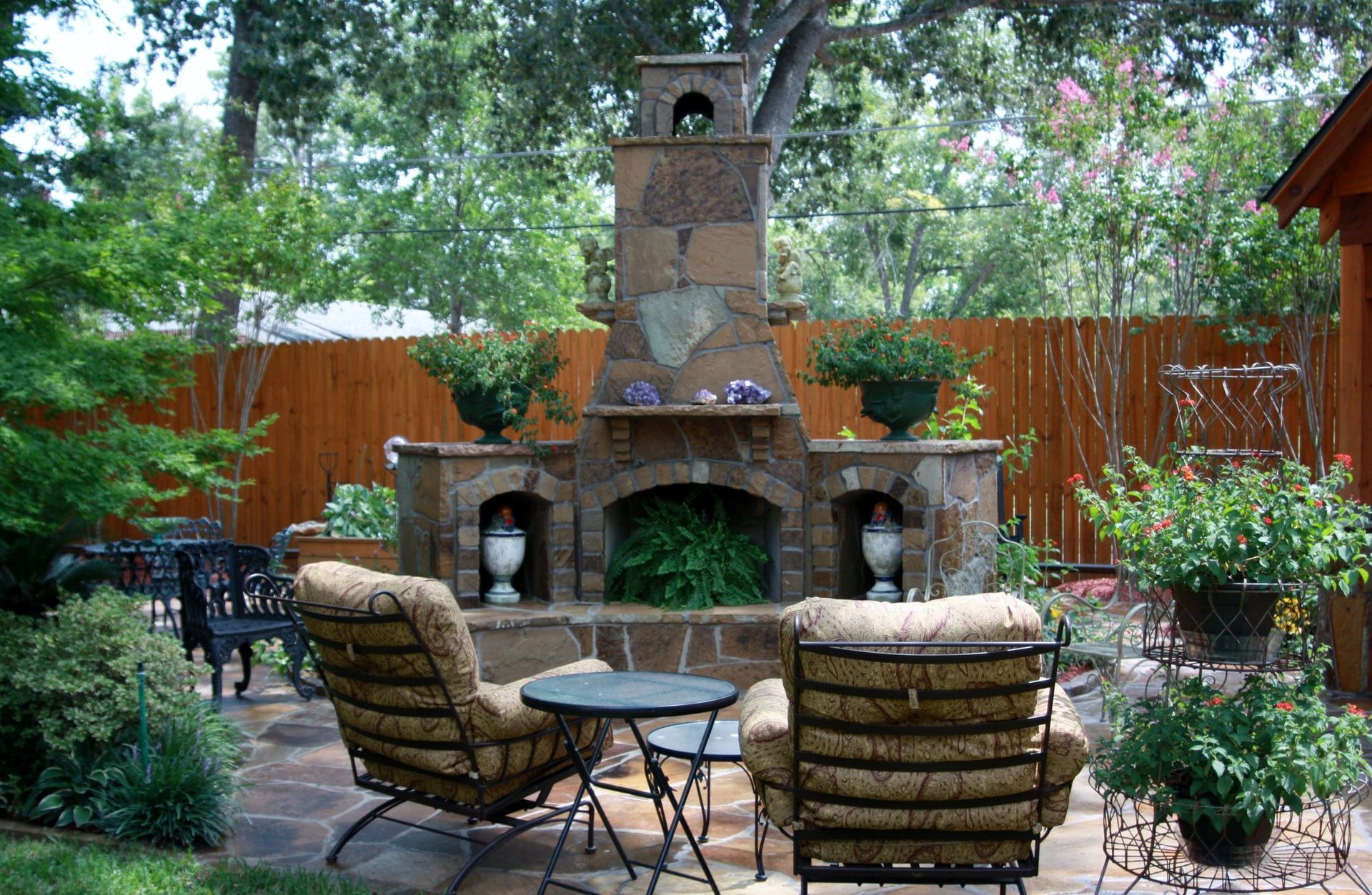 A patio with a fireplace and chairs and a table