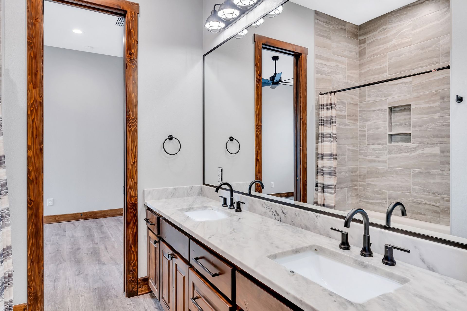 A bathroom with two sinks and a large mirror.