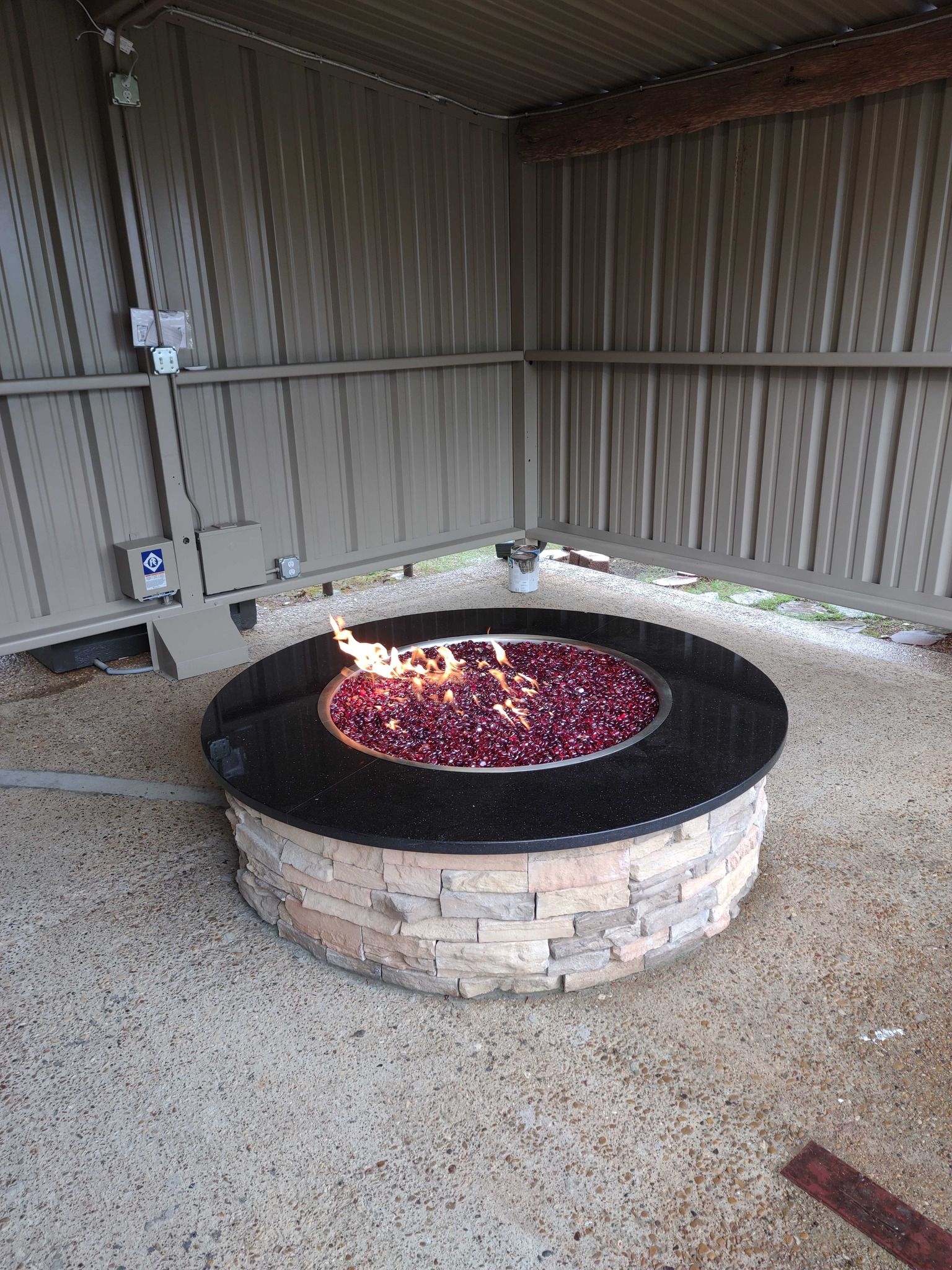 There is a fire pit in the middle of a building.