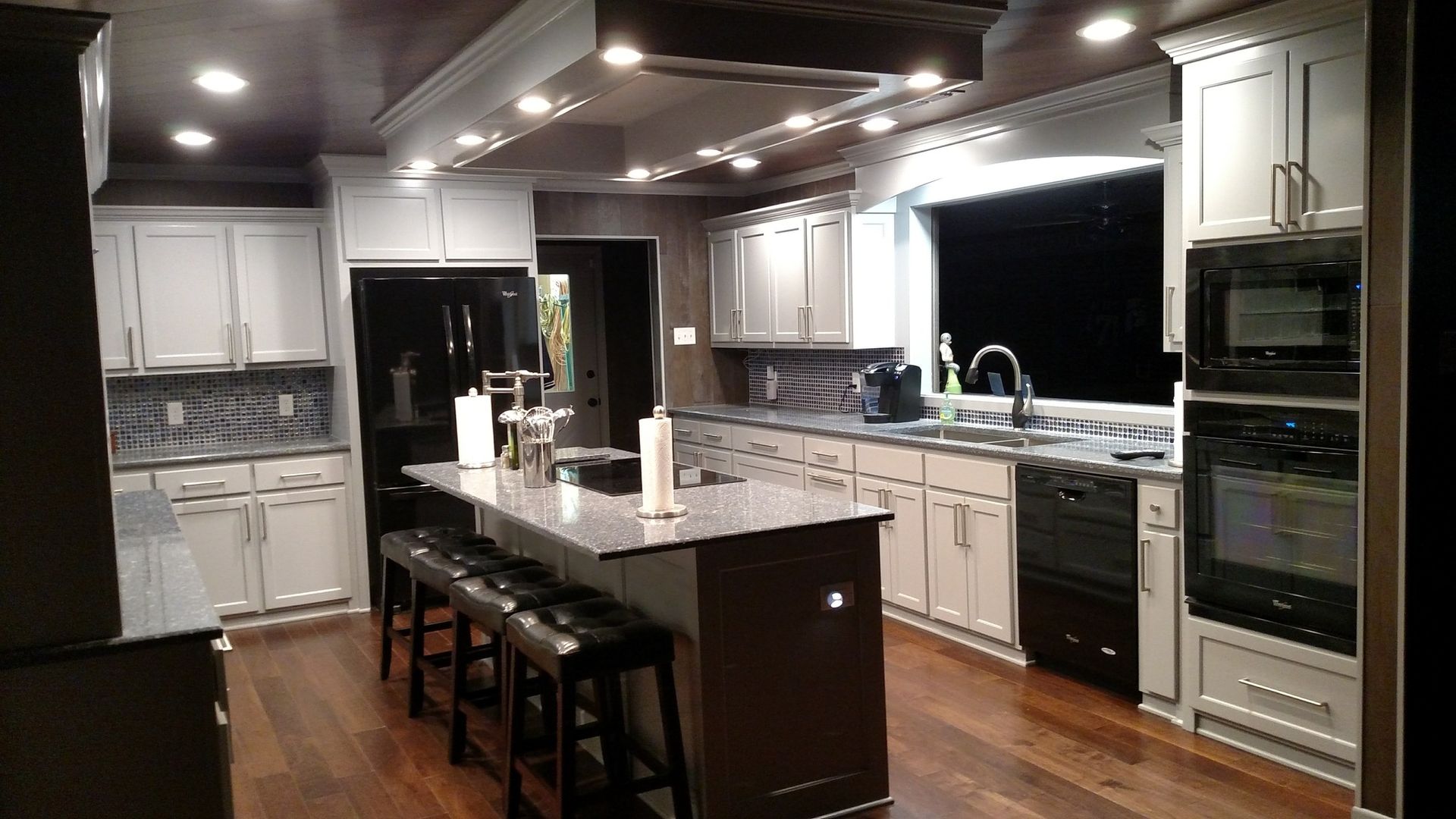 A man wearing a mask is holding a box of pizza