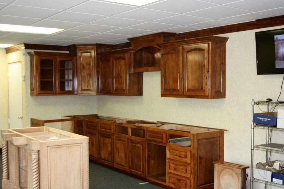 A row of semi trucks are driving down a road